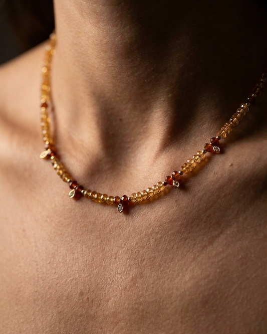 Necklace with amber beads worn by a person